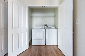 A white laundry room with a washer and dryer